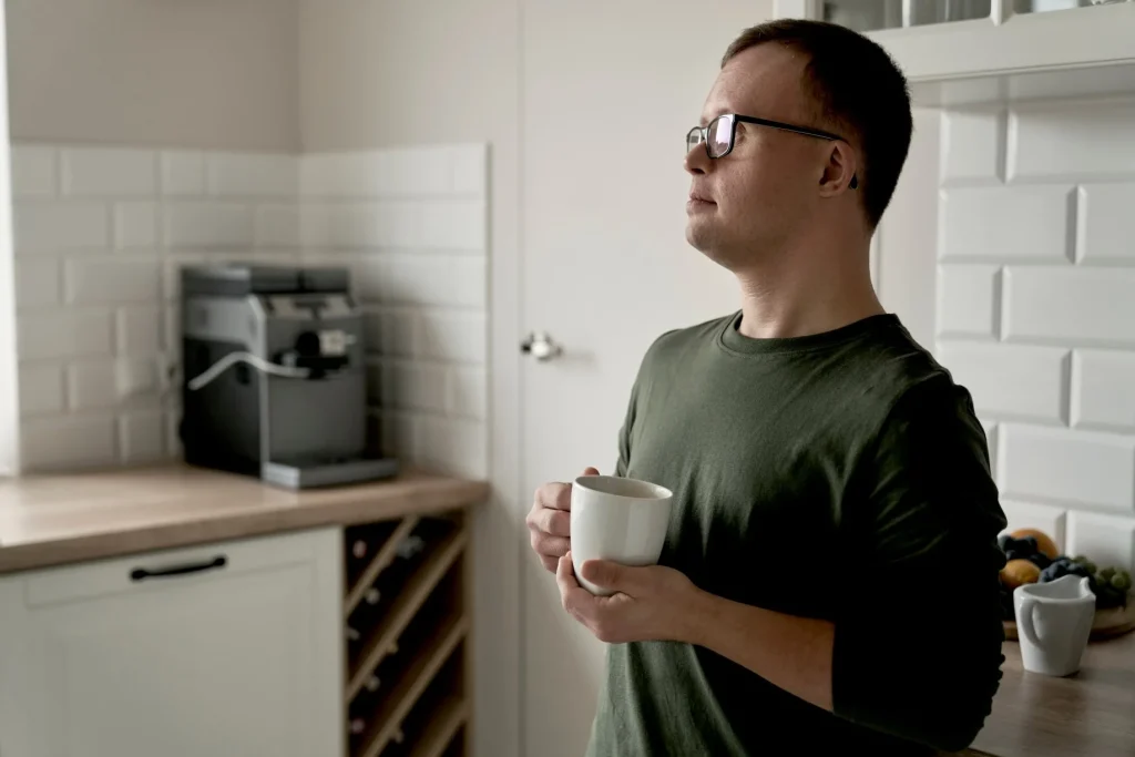Disabled man at home holding mug