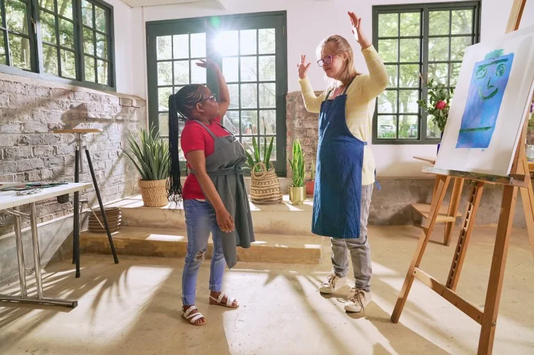 Two disabled friends in art class